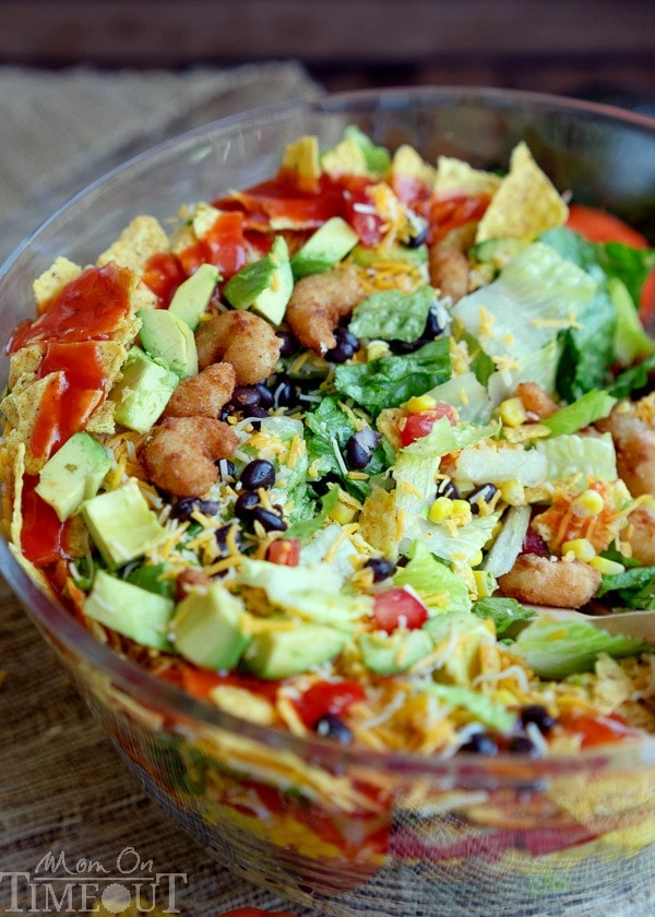 This easy Layered Popcorn Shrimp Taco Salad recipe is perfect for an easy, breezy summer time meal! Layers and layers of flavor make this a meal the whole family will love! | MomOnTimeout.com | #dinner #salad #ad