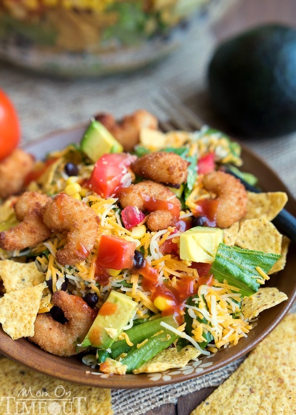 This easy Layered Popcorn Shrimp Taco Salad recipe is perfect for an easy, breezy summer time meal! Layers and layers of flavor make this a meal the whole family will love! | MomOnTimeout.com | #dinner #salad #ad