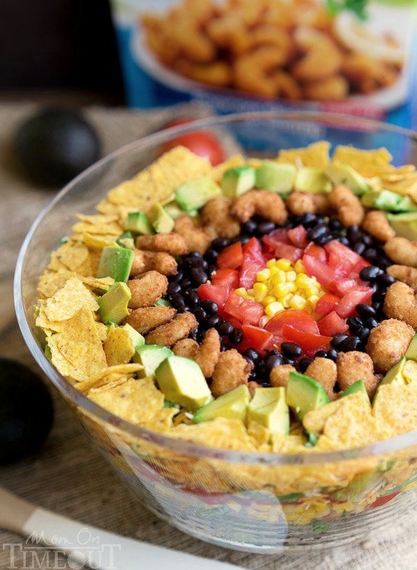 This easy Layered Popcorn Shrimp Taco Salad recipe is perfect for an easy, breezy summer time meal! Layers and layers of flavor make this a meal the whole family will love! | MomOnTimeout.com | #dinner #salad #ad