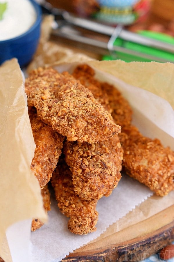 six chicken strips wrapped up in parchment