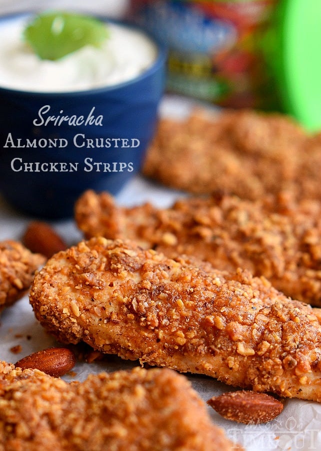 almond crusted chicken strips resting on parchment paper 