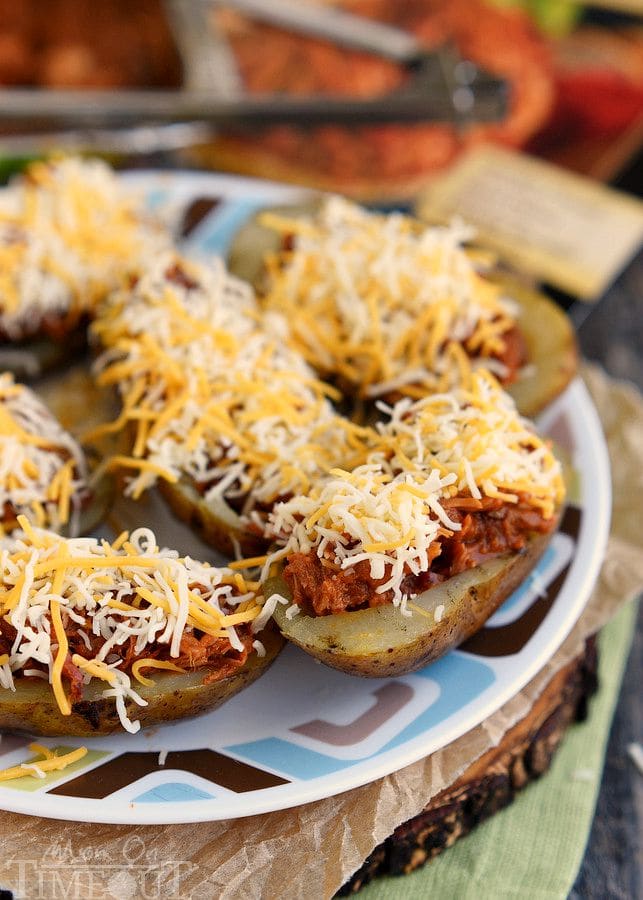 Too hot to cook indoors? Make these Fully Loaded Grilled BBQ Pork Potato Skins tonight! Fun enough for an appetizer yet hearty enough for a main dish, this delicious recipe is cooked straight on the grill and is perfect for all of your summer time entertaining! | MomOnTimeout.com | #recipe #appetizer #game #ad