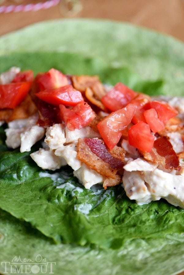 This BLT Chicken Caesar Salad Wrap has all the makings to become your new go-to recipe! Chicken, bacon, Caesar dressing, and tomato are wrapped up in an easy-to-make meal that is perfect for a light dinner or lunch. | MomOnTimeout.com | #recipe #ad