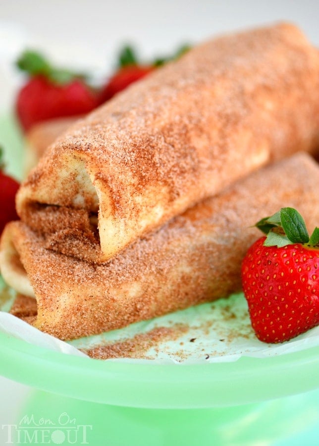 These Chocolate Strawberry Cheesecake Chimichangas are so easy to make and are perfect for a crowd OR an easy weeknight dessert. Fresh strawberries, strawberry cream cheese and chocolate are wrapped in a tortilla, fried to a golden brown and rolled in cinnamon and sugar - totally irresistible! | MomOnTimeout.com