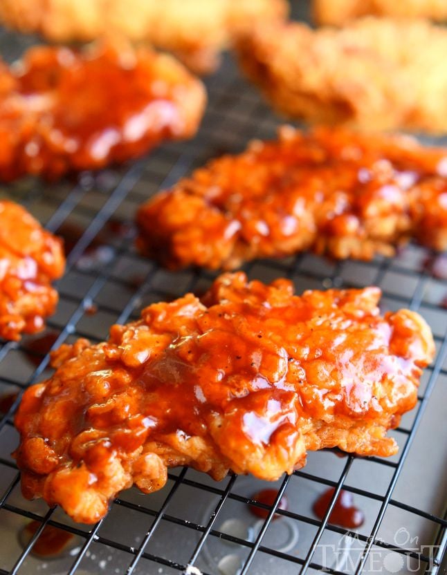  Sticky sweet Honey BBQ Chicken Strips are perfect for dinner or game day! Marinated in buttermilk and perfectly seasoned, these strips are hard to resist! | MomOnTimeout.com