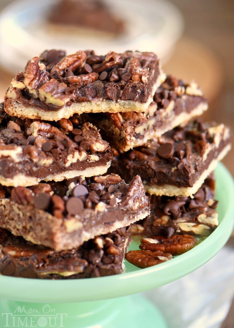 pecan bars piled high on green cake stand