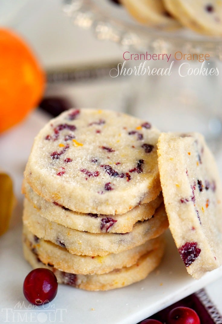 shortbread cookies stacked on white plate with one cookie leaning against the stack