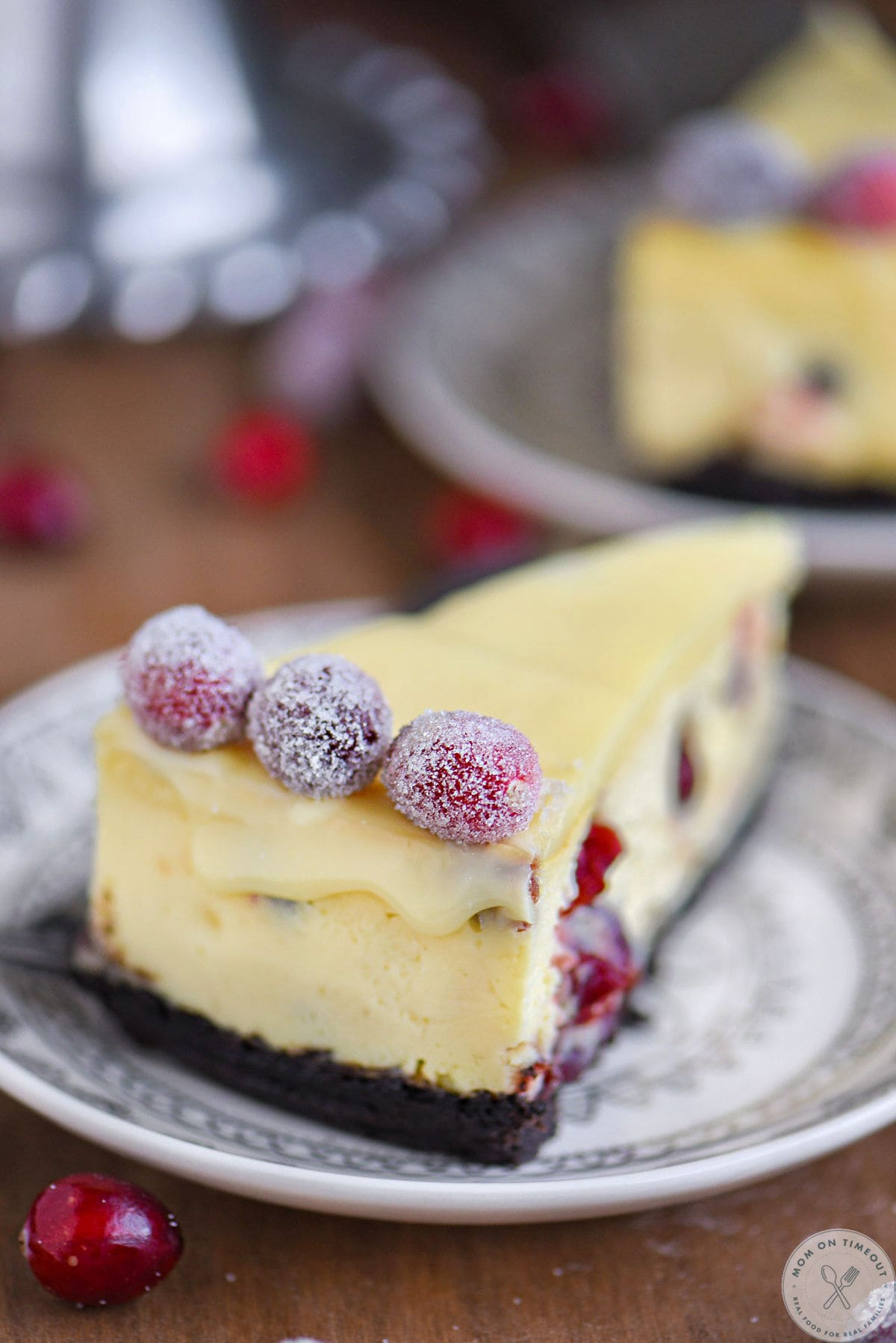 Back side of white chocolate cheesecake on plate.