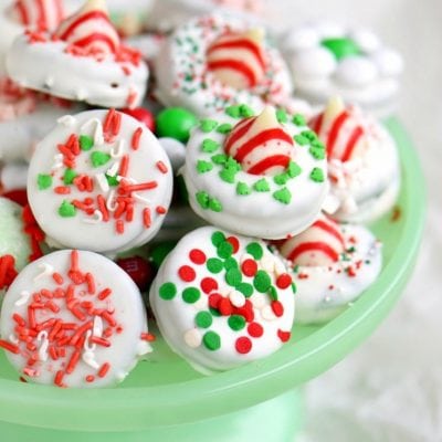 dipped oreo cookies decorated for chirstmas on green cake stand