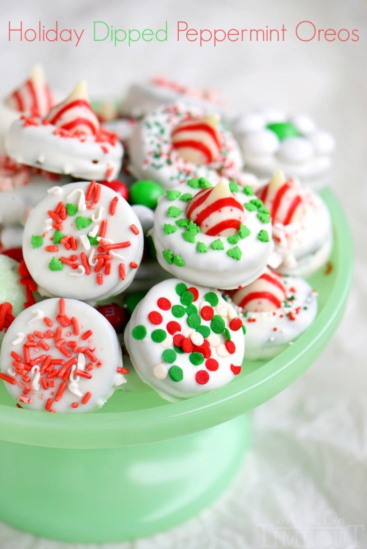 dipped oreo cookies decorated for chirstmas on green cake stand