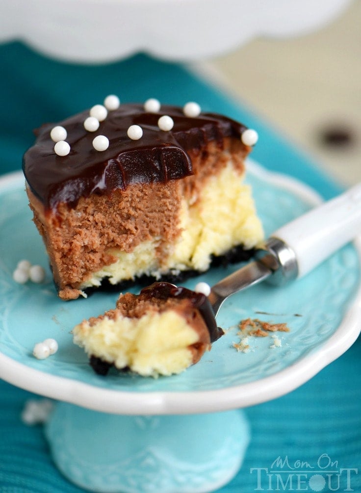 These easy Chocolate Marble Mini Cheesecakes are the perfect treat to make for a crowd! Creamy and decadent, these cheesecakes start with a chocolate crust, creamy chocolate marble cheesecake filling, and are topped with decadent chocolate ganache. // Mom On Timeout #minicheesecakes #cheesecake #chocolate #dessert #mini #momontimeout #recipe #Recipes #desserts #easy ganache topping with sugar pearls on mini cheesecake
