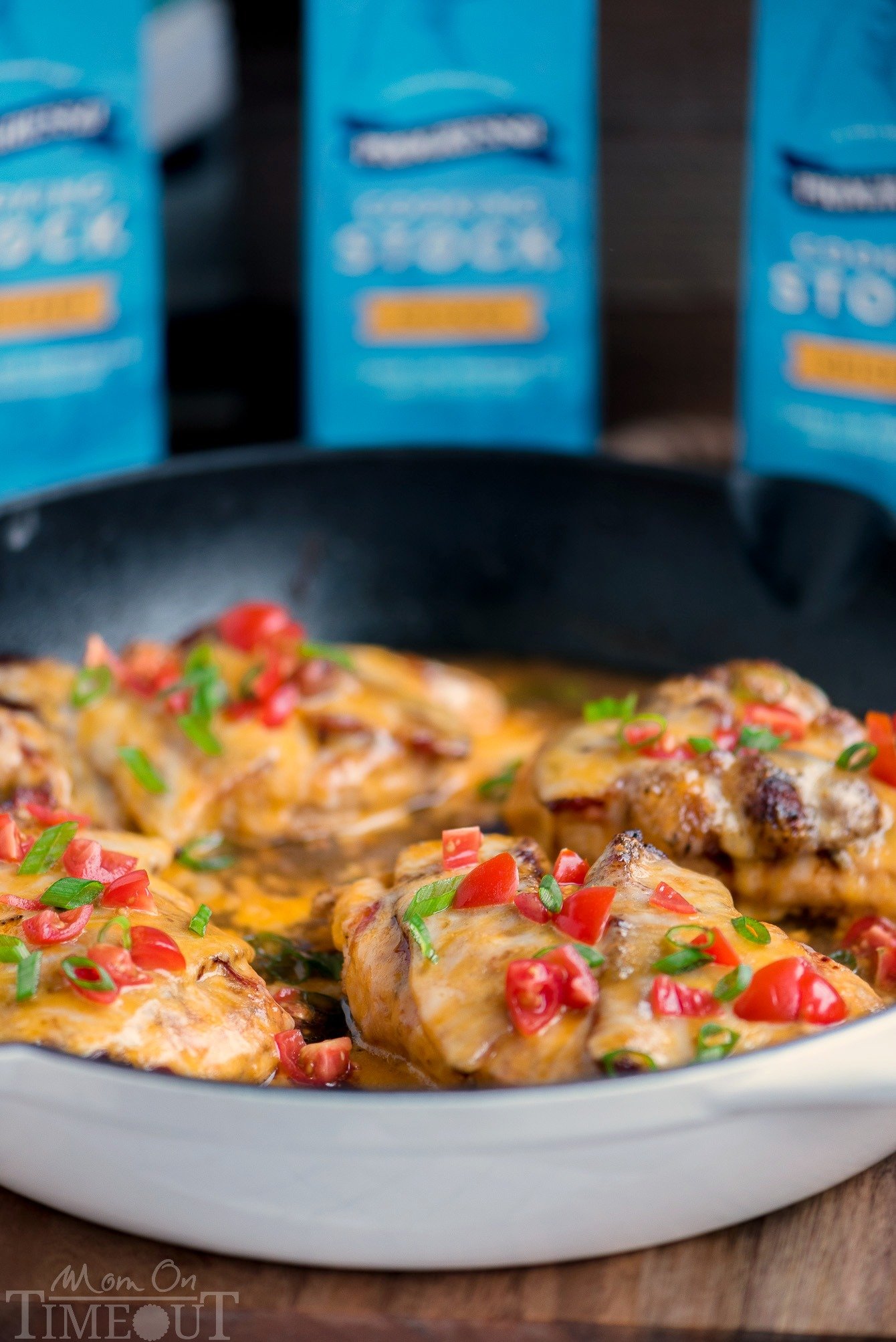 Got 20 minutes? This easy Skillet Monterey Chicken is just what you want to make for dinner tonight...trust me! Chicken, barbecue sauce, bacon, and glorious cheese come together in this delightful yet simple dish. Sure to become a regular request at your home! // Mom On Timeout #montereychicken #chickendinner #skilletdinner #easyrecipe #chicken #bacon #cheese #skillet #recipe skillet monterey chicken in white enamel cast iron skillet