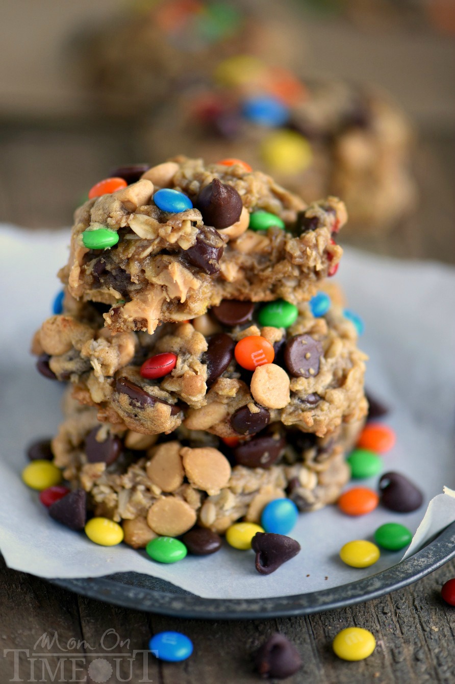 These Monster Peanut Butter Oatmeal Cookies have it ALL! Each bite is filled with chewy oats, peanut butter, chocolate chips and M&M's! Truly the perfect cookie! | Mom On Timeout #monstercookies #cookies #peanutbuttercookies #oatmealcookies #baking #dessert #desserts Monster Peanut Butter Oatmeal Cookies recipe with bite out of cookie