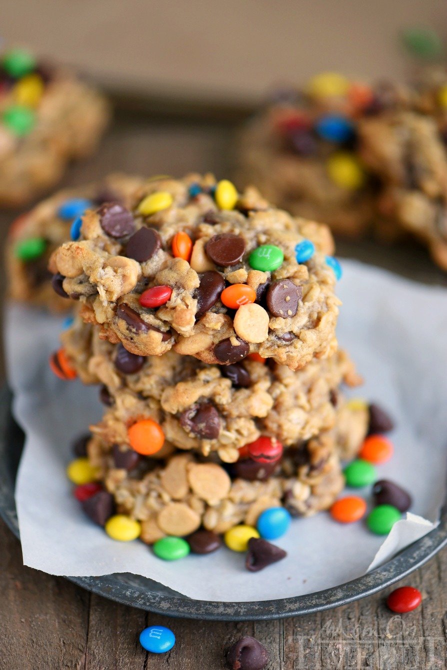 These Monster Peanut Butter Oatmeal Cookies have it ALL! Each bite is filled with chewy oats, peanut butter, chocolate chips and M&M's! Truly the perfect cookie! | Mom On Timeout #monstercookies #cookies #peanutbuttercookies #oatmealcookies #baking #dessert #desserts front view of These Monster Peanut Butter Oatmeal Cookies