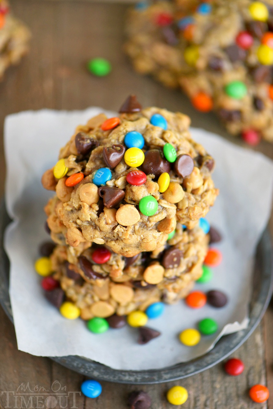 These Monster Peanut Butter Oatmeal Cookies have it ALL! Each bite is filled with chewy oats, peanut butter, chocolate chips and M&M's! Truly the perfect cookie! | Mom On Timeout #monstercookies #cookies #peanutbuttercookies #oatmealcookies #baking #dessert #desserts Monster Peanut Butter Oatmeal Cookies stacked on plate