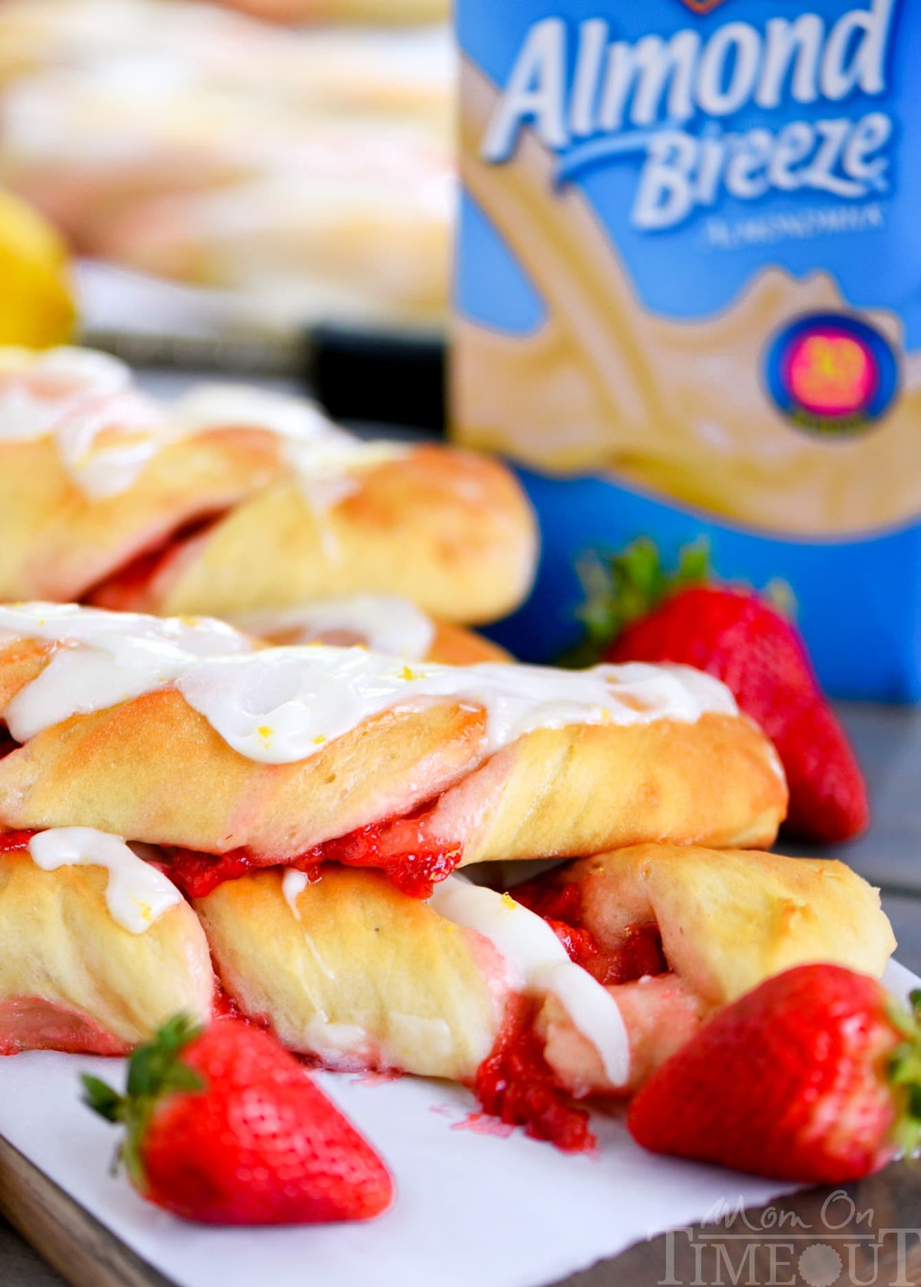 Strawberry Twists with Lemon Cream Cheese Glaze are sure to become your new favorite addition to Sunday brunch! A homemade strawberry filling makes these twists extra special and delicious and the lemon cream cheese glaze is going to knock your socks off! | Mom On Timeout