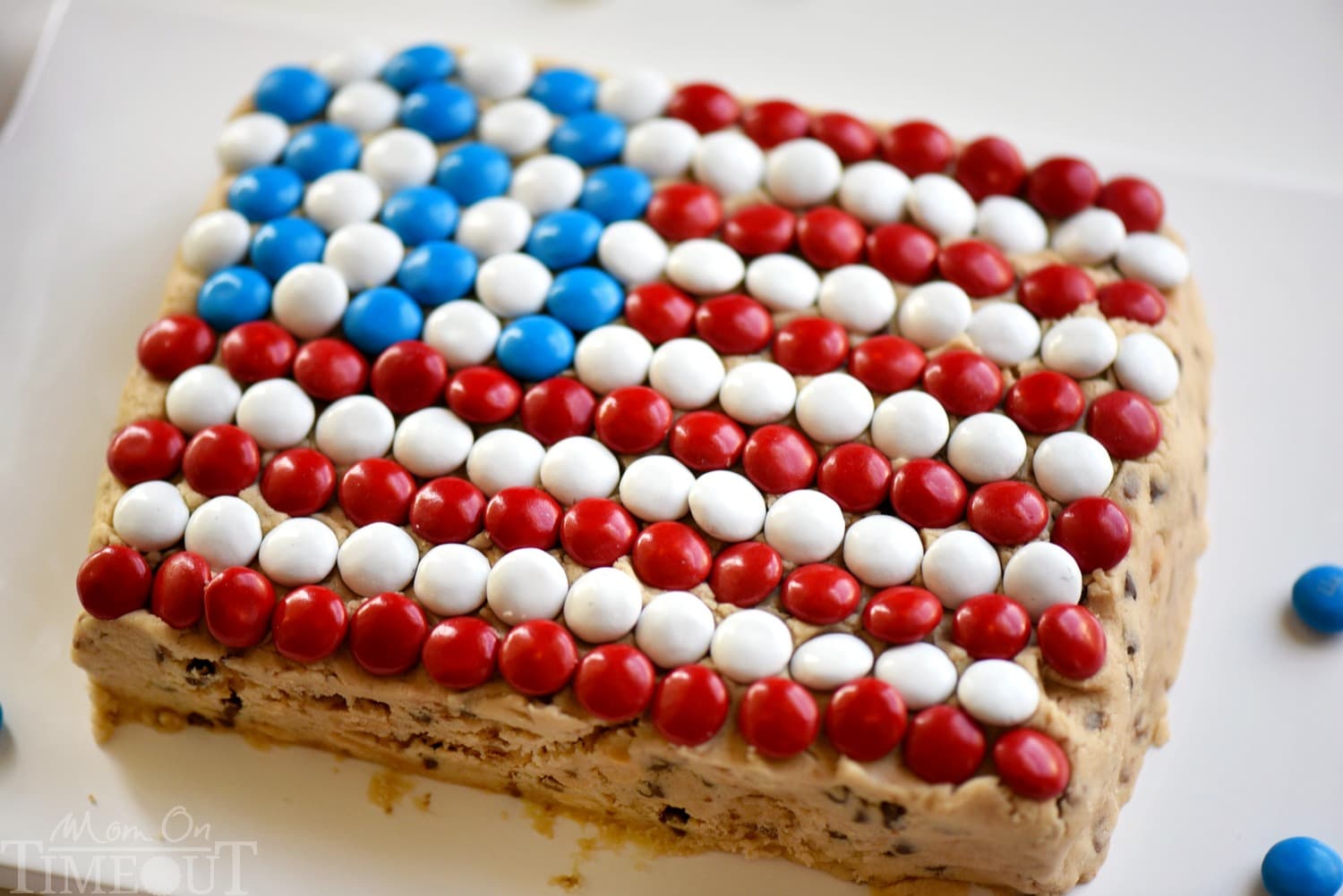 Celebrate with this outrageous Chocolate Chip Cookie Dough Flag Dip this 4th of July weekend! Edible chocolate chip cookie dough is loaded with toffee bits and peanut butter chips for the most delicious dip ever! Decorated in red, white, and blue, this easy dessert recipe is perfect for Memorial Day and Labor Day weekend as well!