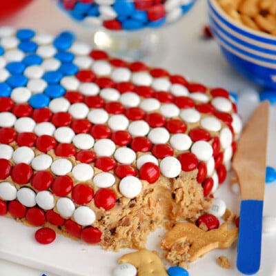 Angled overhead shot of chocolate chip cookie dough dip shaped and decorated like the USA flag.