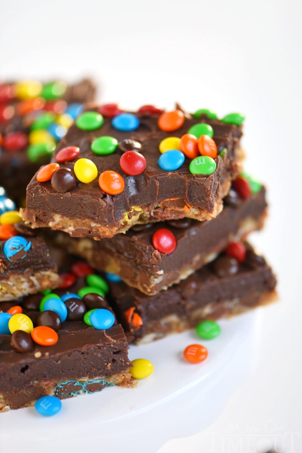No one can resist these EASY Monster Fudge Bars! Oatmeal chocolate chip cookie bars topped with easy fudge and mini M&M's! This is one decadent treat!