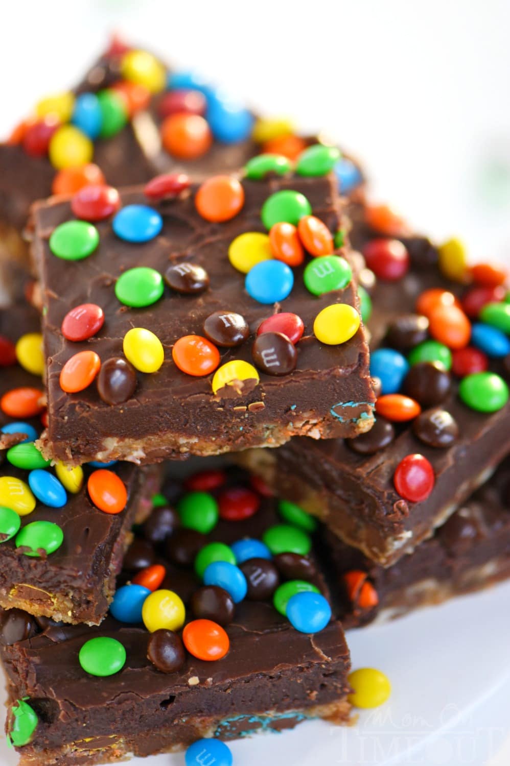 No one can resist these EASY Monster Fudge Bars! Oatmeal chocolate chip cookie bars topped with easy fudge and mini M&M's! This is one decadent treat!