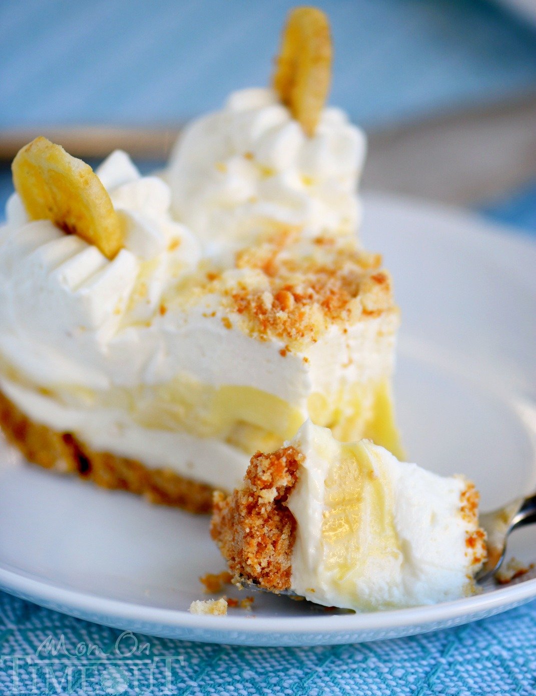 slice of banana pudding cheese on white plate with bite on fork