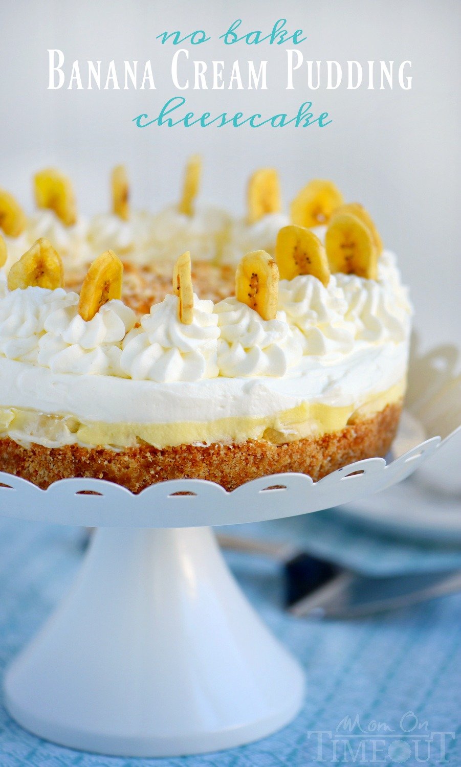 banana-cream-pudding cheesecake on white cake stand with banana chips for decoration