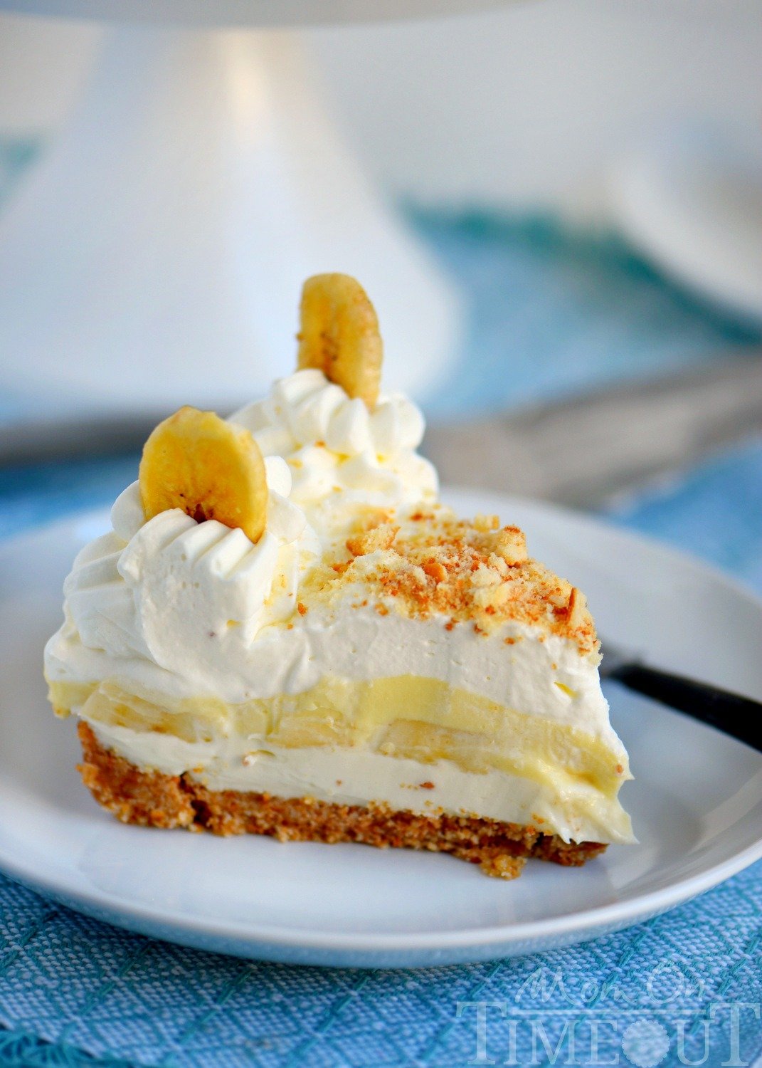 slice of No Bake Banana Cream Pudding Cheesecake on white plate with fork