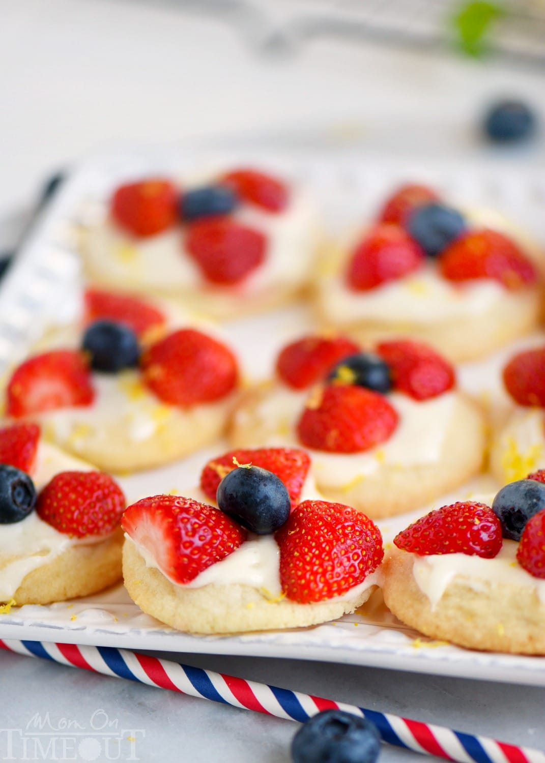 Almost too pretty to eat, these Berries 'N Cream Cookies are the easiest recipe you'll make all summer long! Sweet sugar cookies are topped with a bright, lemon cream cheese frosting and fresh berries! Soooo good!