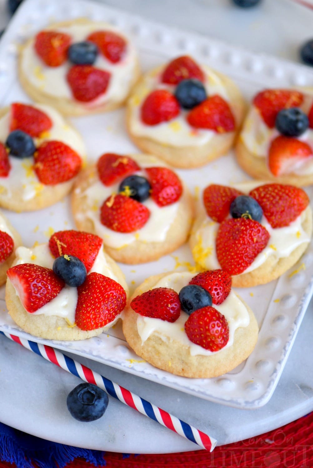 Almost too pretty to eat, these Berries 'N Cream Cookies are the easiest recipe you'll make all summer long! Sweet sugar cookies are topped with a bright, lemon cream cheese frosting and fresh berries! Soooo good!