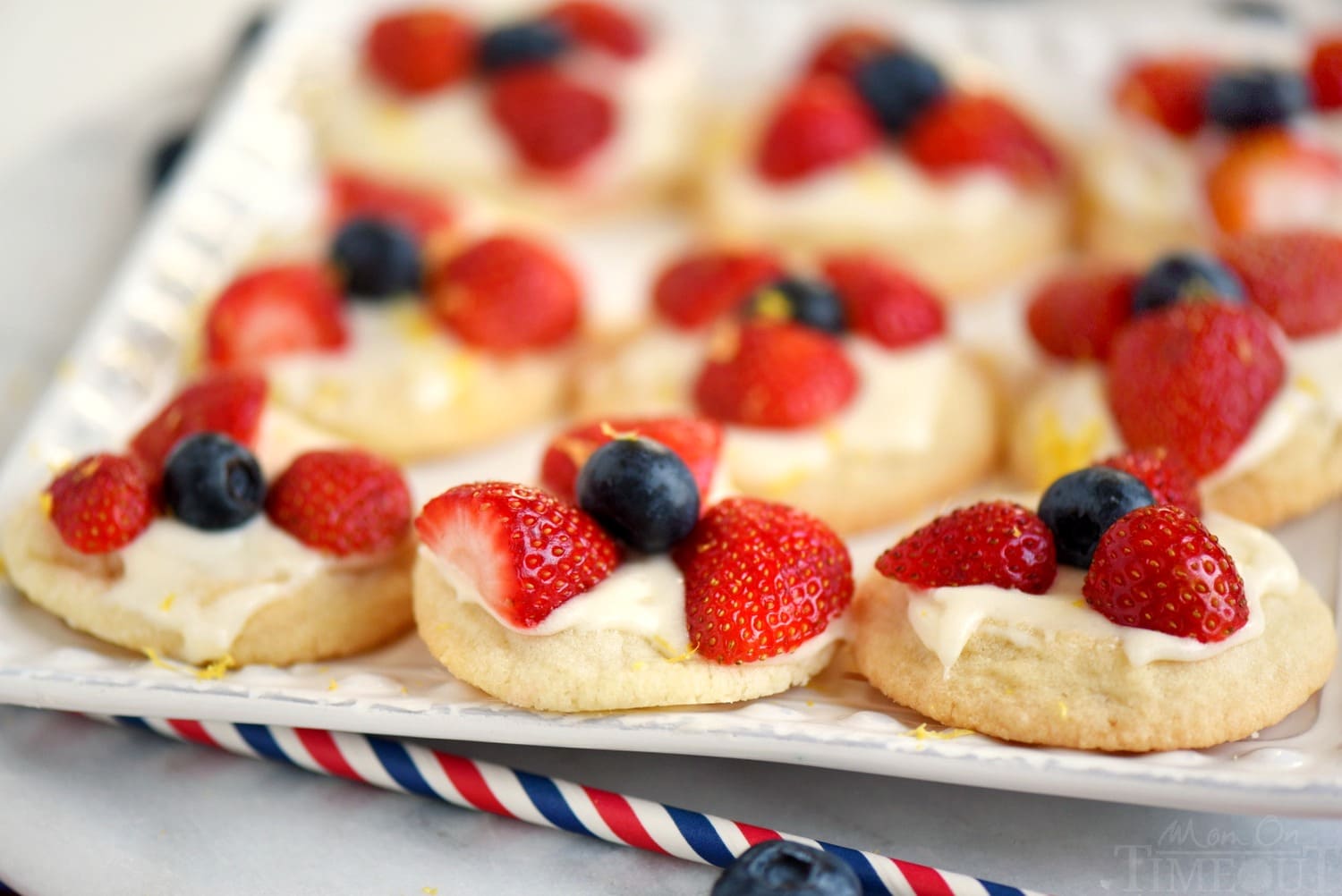 Almost too pretty to eat, these Berries 'N Cream Cookies are the easiest recipe you'll make all summer long! Sweet sugar cookies are topped with a bright, lemon cream cheese frosting and fresh berries! Soooo good!