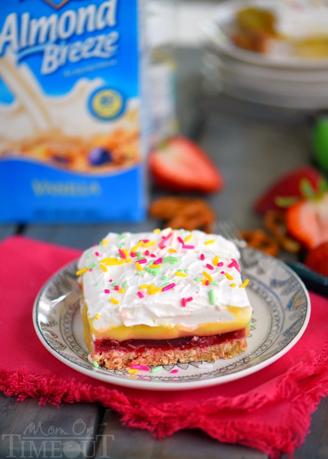 This easy No Bake Strawberry Pretzel Layered Dessert is sure to become a new family favorite! A graham cracker-pretzel crust is topped with a sweet strawberry jell-o layer, rich vanilla pudding and creamy whipped topping! Don't forget the sprinkles!