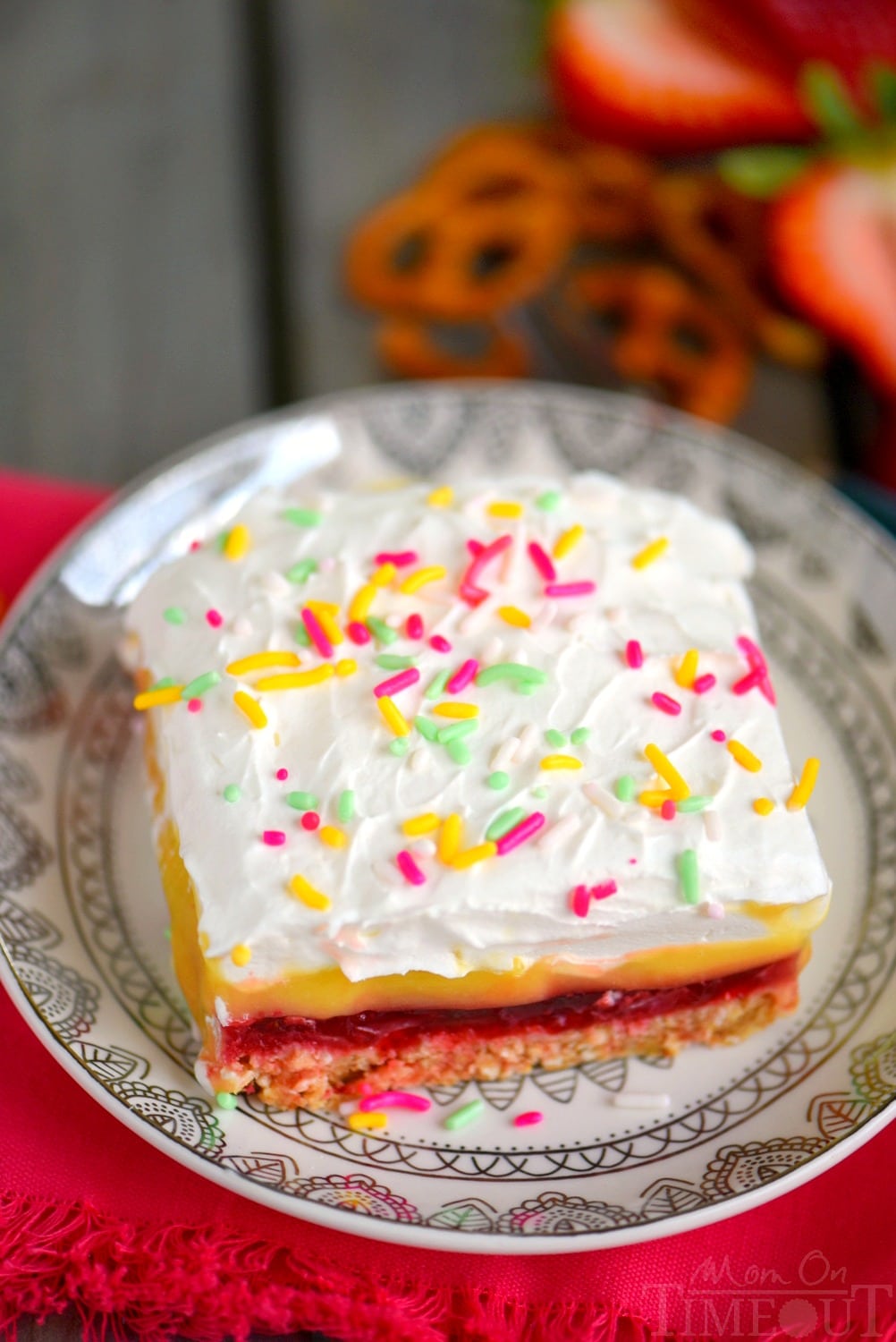 This easy No Bake Strawberry Pretzel Layered Dessert is sure to become a new family favorite! A graham cracker-pretzel crust is topped with a sweet strawberry jell-o layer, rich vanilla pudding and creamy whipped topping! Don't forget the sprinkles!