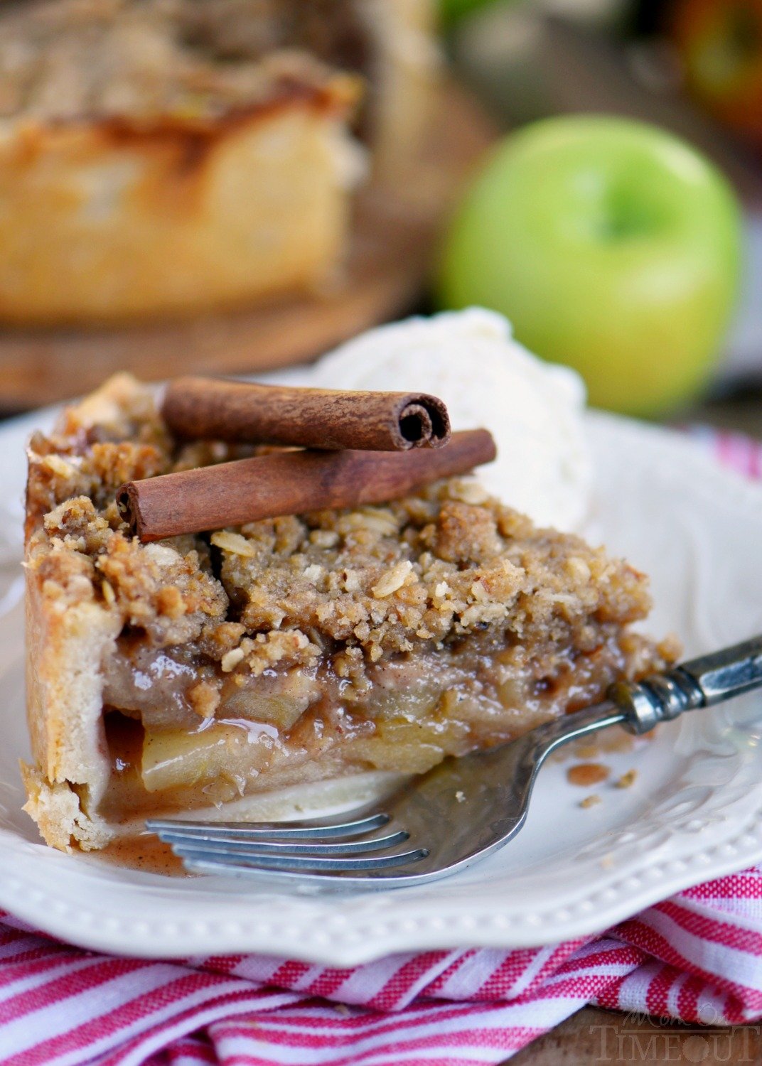 Deep Dish Dutch Apple Pie is loaded with a spiced apple filling and topped with a crunchy, sweet, pecan streusel topping. Best served with a big scoop of vanilla ice cream and caramel sauce. This is THE dessert for the fall season! | Mom On Timeout