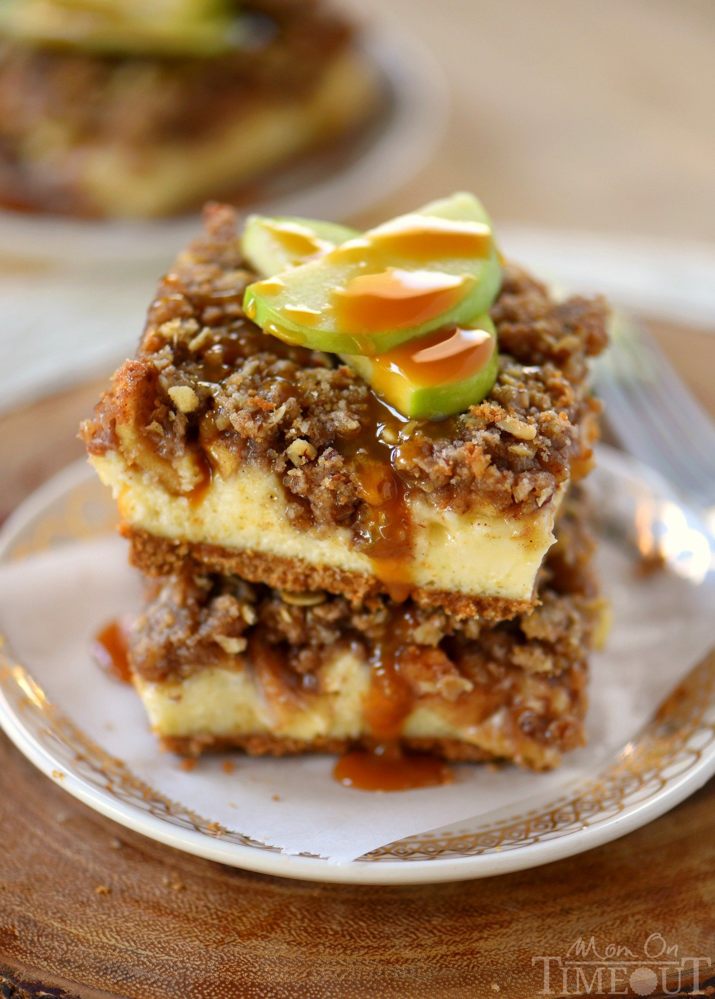 Apple season has arrived and to celebrate, I'm sharing these outrageous Dutch Apple Pie Cheesecake Bars! A graham cracker crust spiced with cinnamon, a decadent vanilla bean cheesecake layer, apples tossed in sugar, cinnamon, and nutmeg and finally my favorite streusel topping. Yeah, WOW. | Mom On Timeout