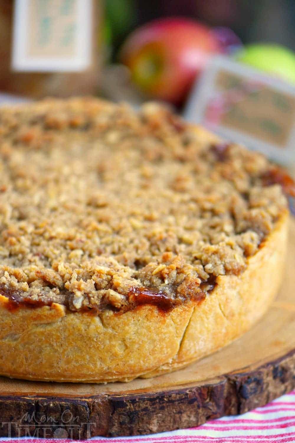 Deep Dish Dutch Apple Pie is loaded with a spiced apple filling and topped with a crunch, sweet, pecan streusel topping. Best served with a big scoop of vanilla ice cream and caramel sauce. This is THE dessert for the fall season! | Mom On Timeout