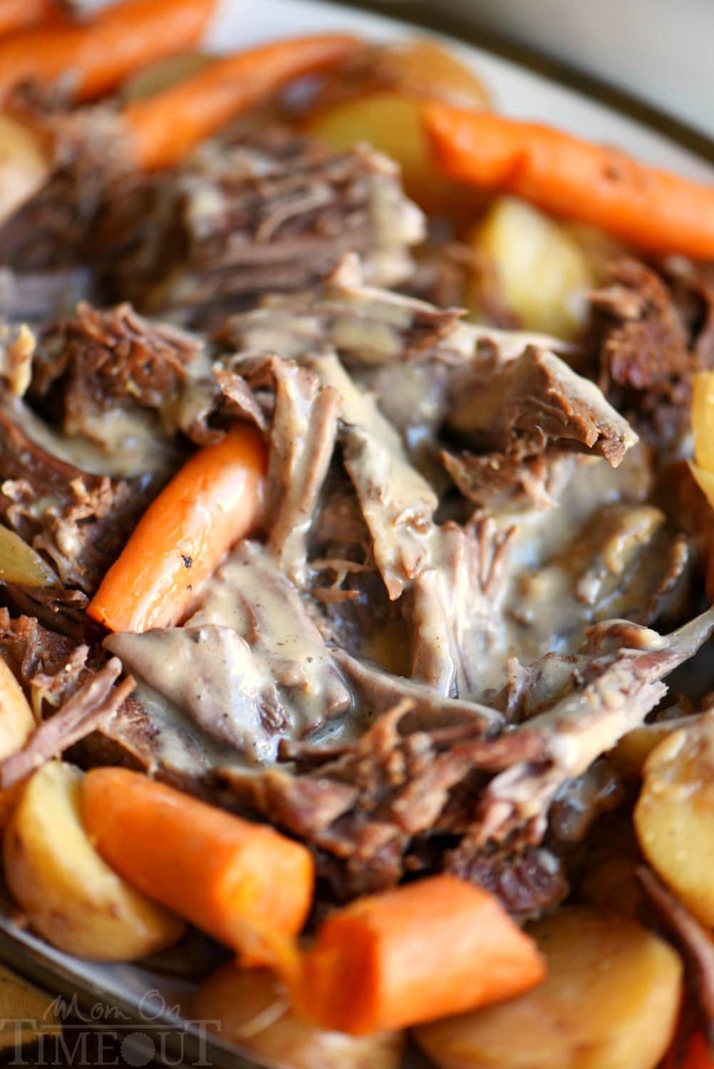 pot roast plated with gravy and vegetables