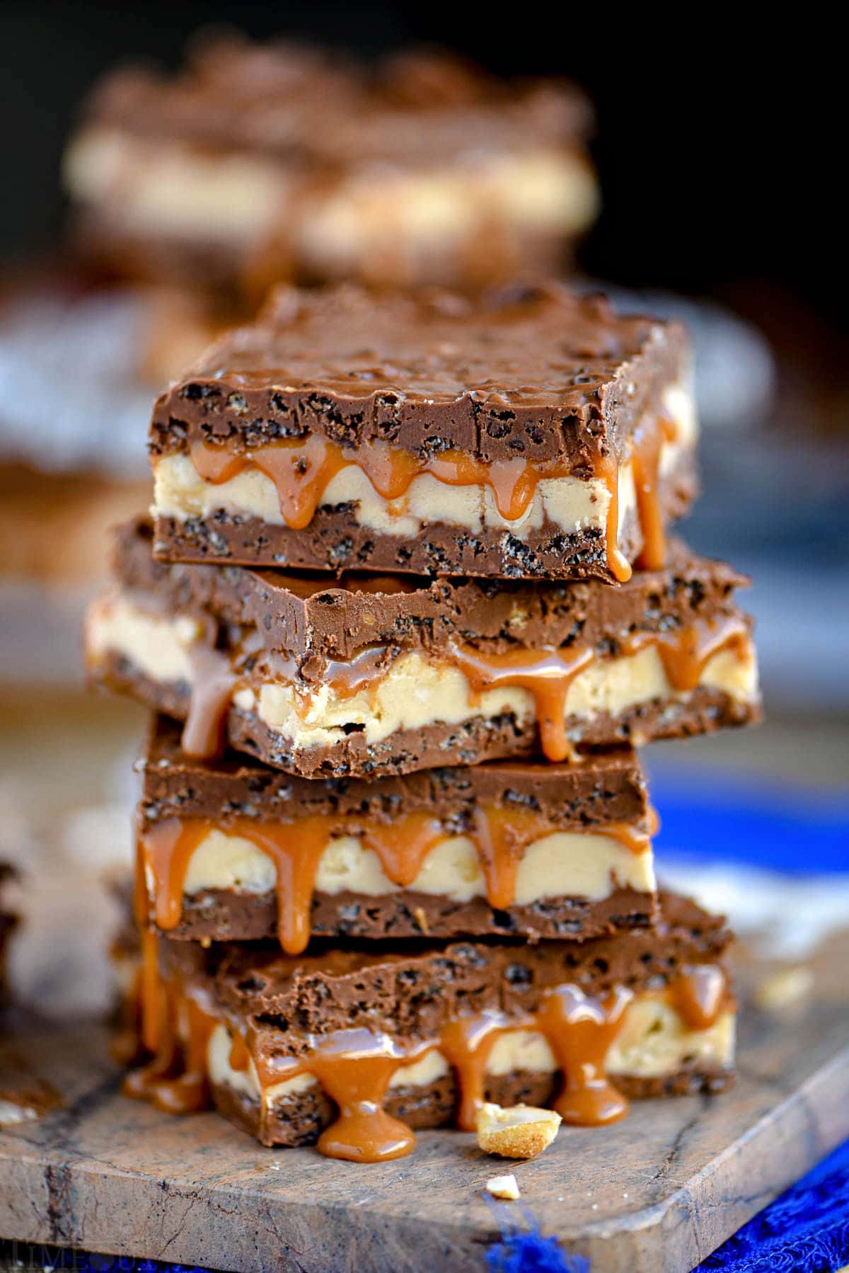 caramel nougat snickers bars stacked on each other, four high.