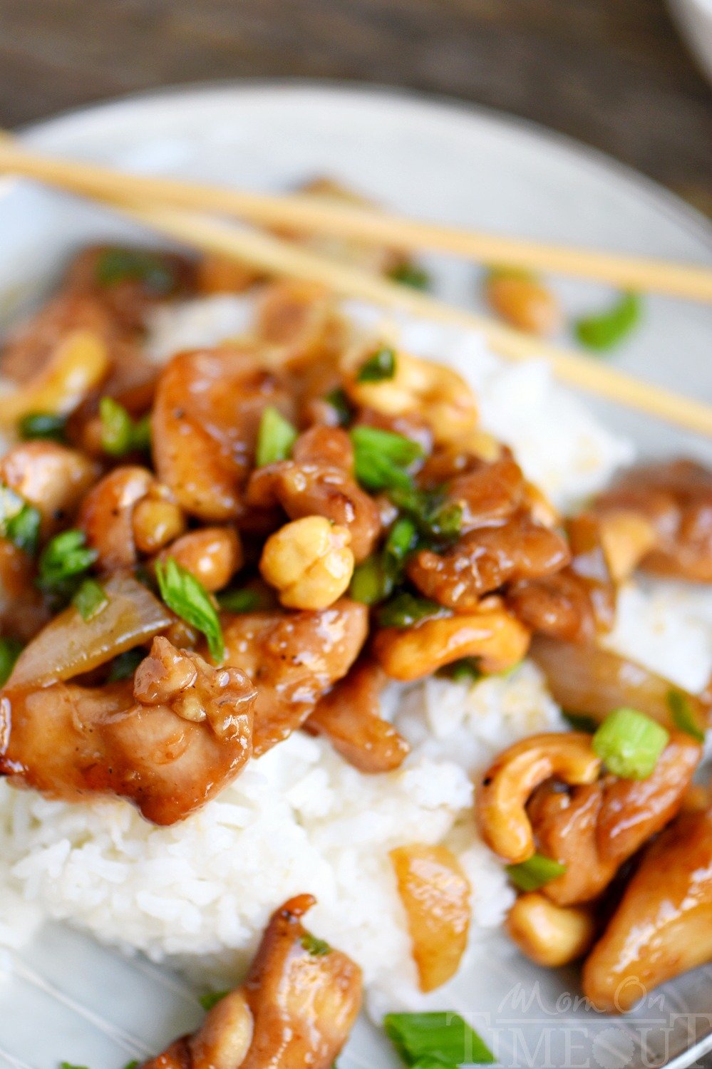 easy cashew chicken recipe with sauce on plate with chopsticks