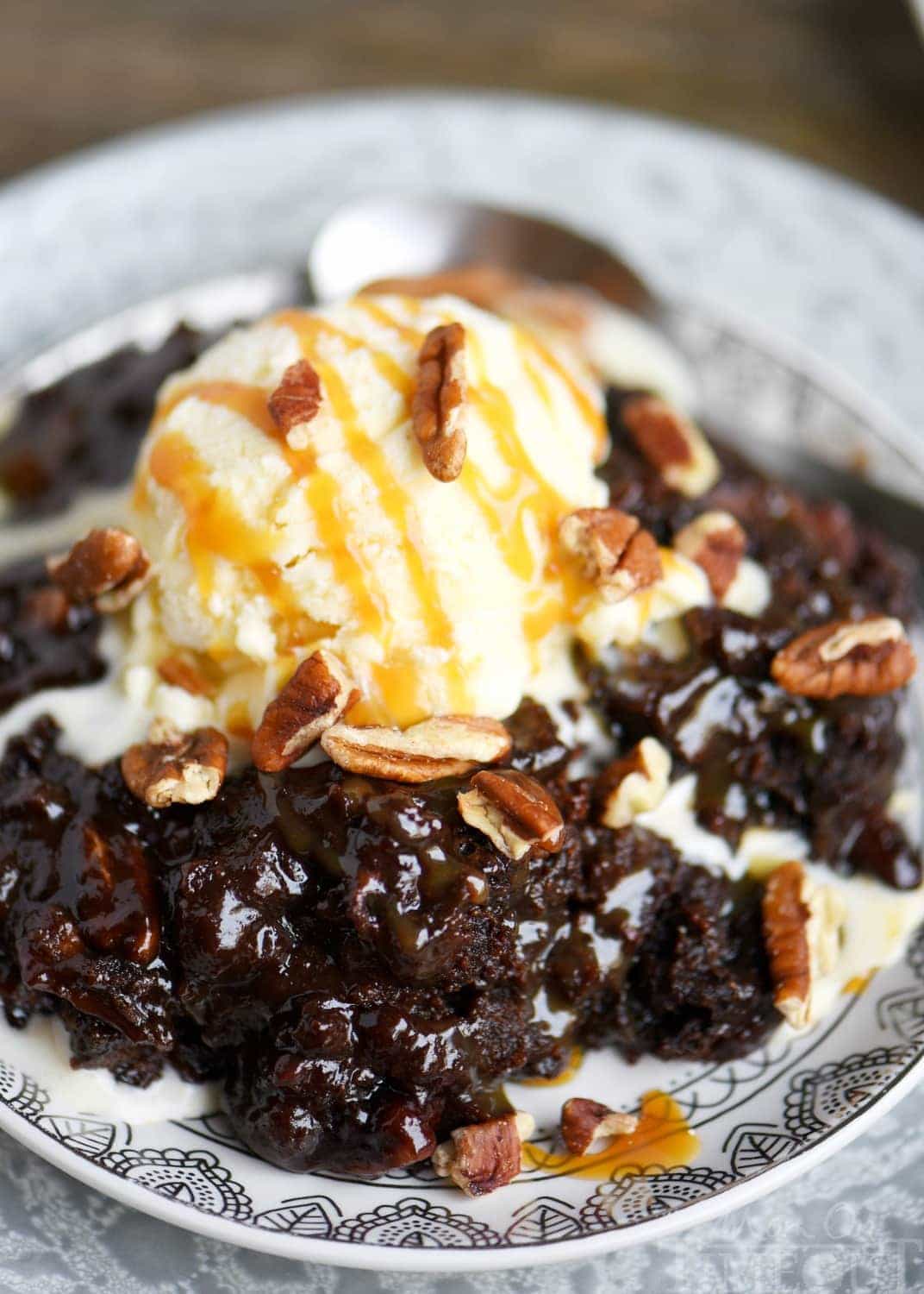 Fabulously gooey and outrageously delicious, these Slow Cooker Hot Fudge Turtle Brownies are going to rock your world! Hot fudge sauce, caramel, pecans, and gooey brownies come together for one irresistible dessert! // Mom On Timeout