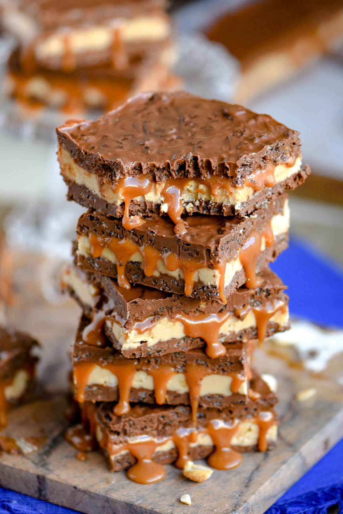 stack of bars with nougat, caramel and crispy chocolate layers. Top bar has a bite taken.