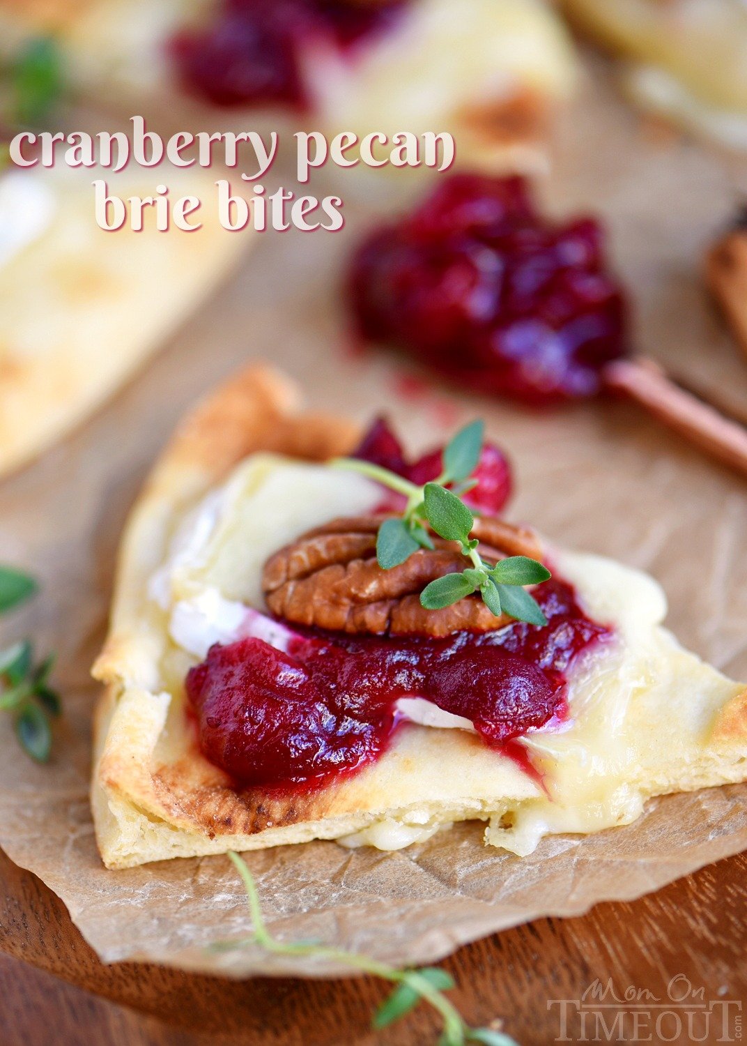 These Cranberry Pecan Brie Bites are perfect for holiday entertaining! Whether you make them for Thanksgiving, Christmas, or New Year's, no one will be able to resist the gooey melted brie, tart cranberry sauce, and toasted pecan atop a piece of naan! Easy and fabulous - just what holiday entertaining should be! // Mom On Timeout #appetizer #brie #cranberry #holidays #thanksgiving #christmas Cranberry Pecan Brie Bites