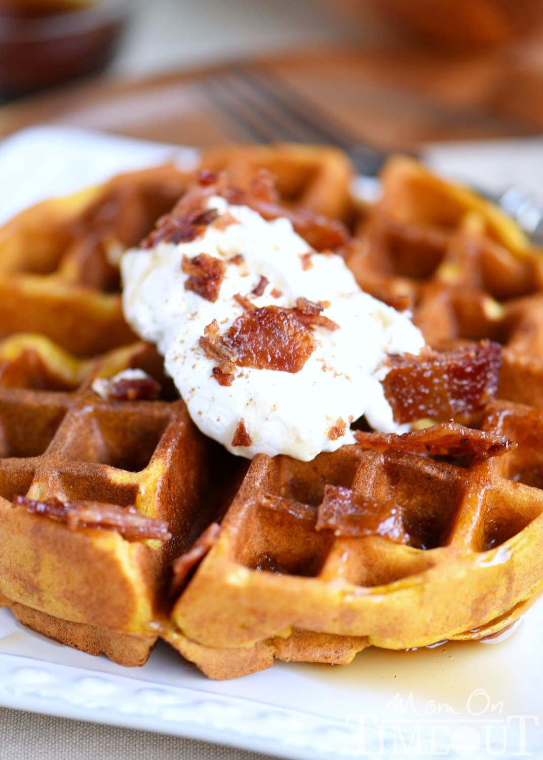 These Pumpkin Spice Maple Bacon Waffles are the perfect way to celebrate the most important meal of the day! Great for the holidays and all fall long! You're going to love the spiced maple bacon that's inside each waffle - so good! // Mom On Timeout