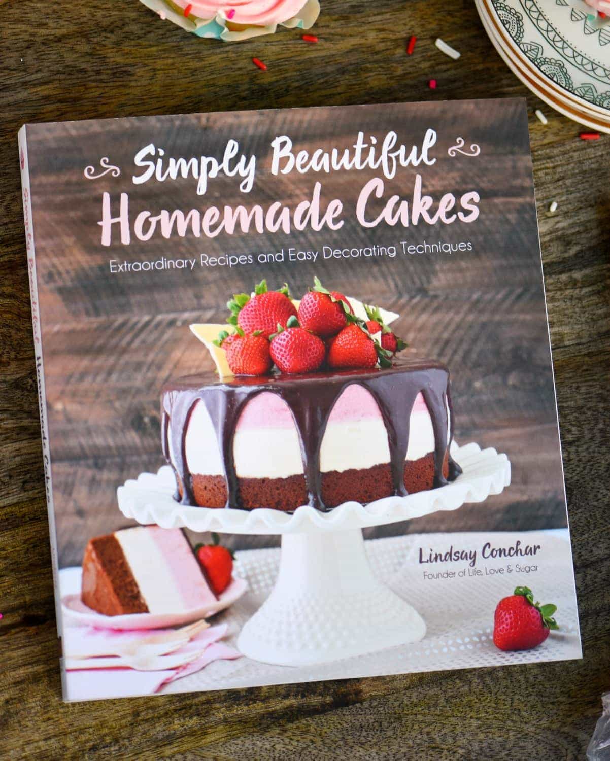 These Cherry Almond Cupcakes are so bright and festive - they're hard to resist! A beautiful almond cupcake, made from scratch, is topped with a cherry almond frosting that is just delightful! Topped with a cherry, these cupcakes are party-ready! // Mom On Timeout