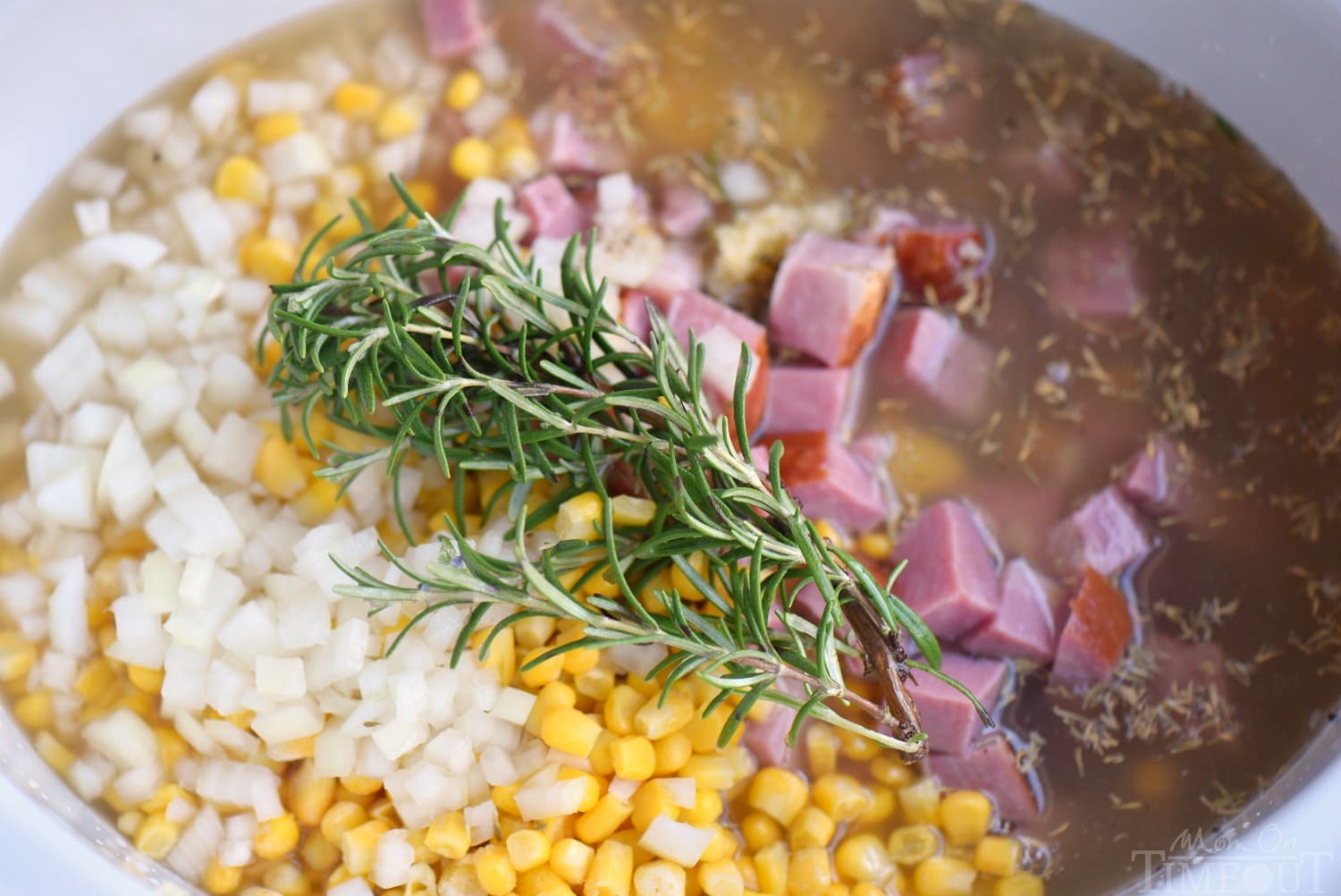 Love slow cooker recipes? This one is for you! This Slow Cooker Rosemary Potato Soup with Ham and Corn is all about filling your belly with goodness and warmth! Weeknight dinners have never tasted this good! // Mom On Timeout