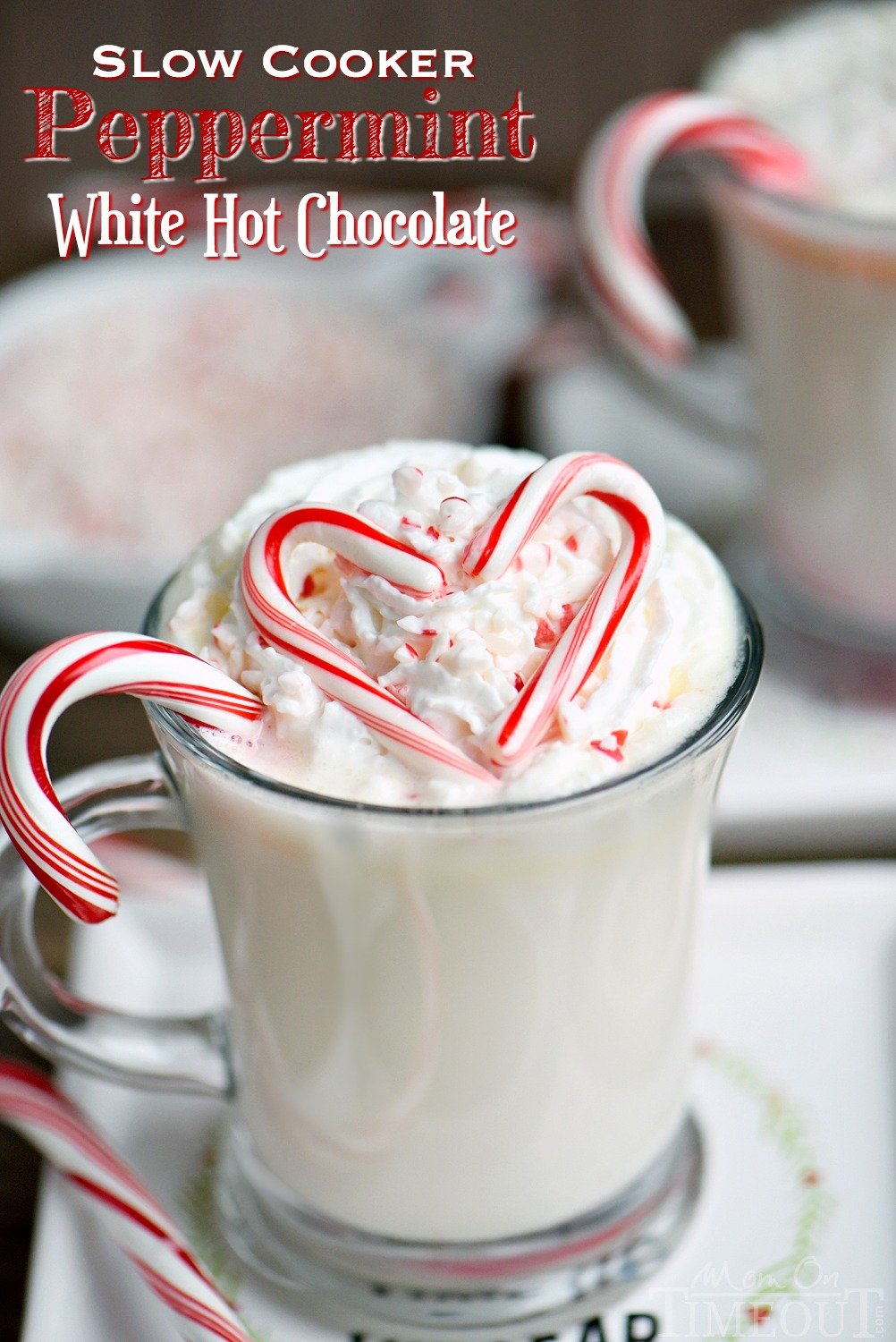 Creamy and decadent Slow Cooker Peppermint White Hot Chocolate! This easy recipe is the perfect way to warm up on a chilly day! Top with whipped cream and crushed candy canes for the ultimate peppermint experience! // Mom On Timeout