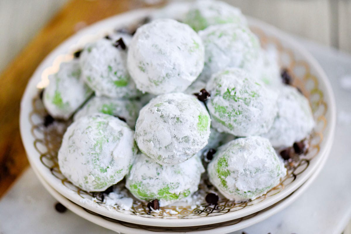 small dessert plate topped with a pile of snowball cookies.