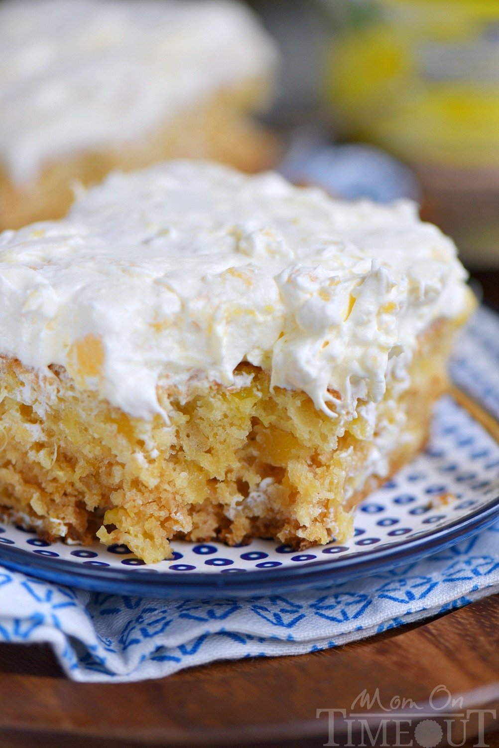 This Practically Perfect Pineapple Cake is loaded with pineapple flavor! Made without butter or oil, it's incredibly moist and topped with a delicious pineapple fluff frosting! // Mom On Timeout