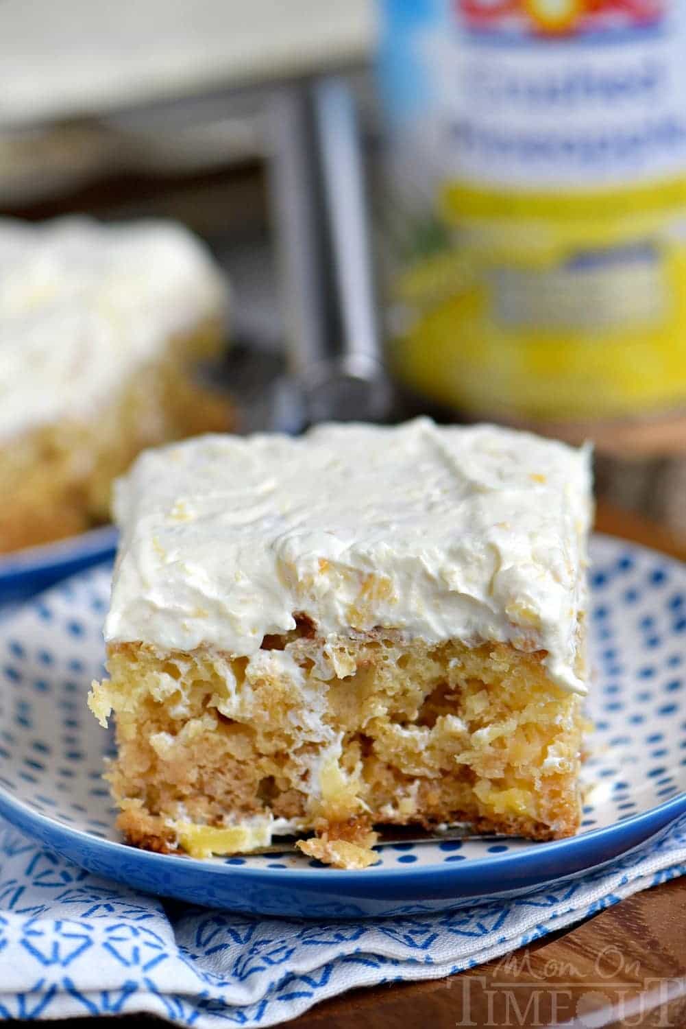 This Practically Perfect Pineapple Cake is loaded with pineapple flavor! Made without butter or oil, it's incredibly moist and topped with a delicious pineapple fluff frosting! // Mom On Timeout