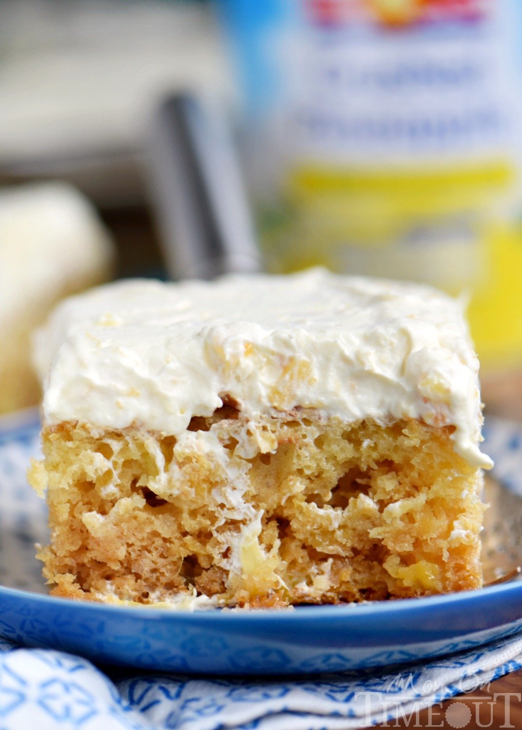 This Practically Perfect Pineapple Cake is loaded with pineapple flavor! Made without butter or oil, it's incredibly moist and topped with a delicious pineapple fluff frosting! // Mom On Timeout