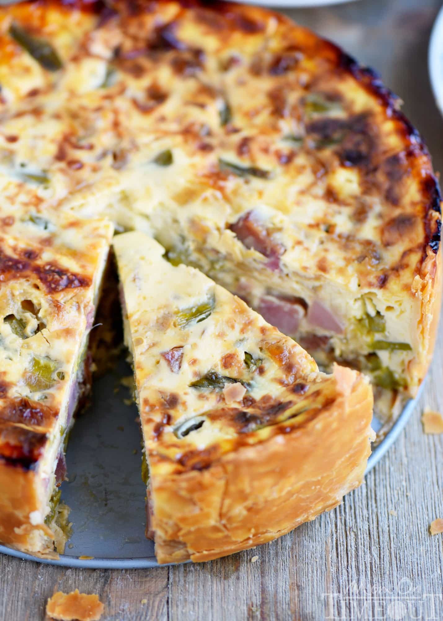 This Deep Dish Ham and Asparagus Quiche with caramelized onions is the perfect addition to your holiday brunch menu! Make it the day before and serve cold or room temperature - both ways are delicious! Also makes a hearty dinner! // Mom On Timeout